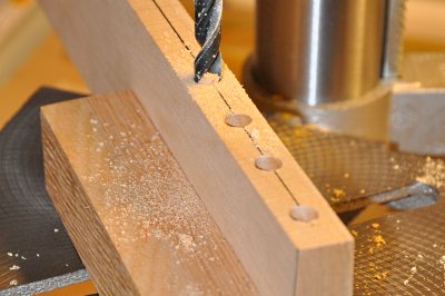Drilling joiner holes in basswood stock.